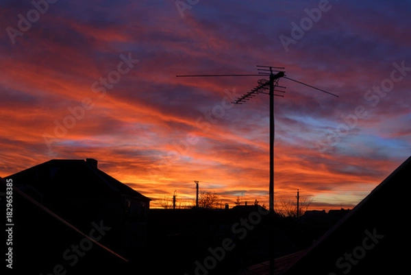 Obraz Dramatic sunset and TV antenna