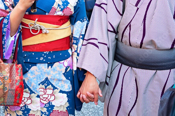 Obraz Couple in traditional Japanese kimono walking at temple with sunset in Kyoto, Japan	