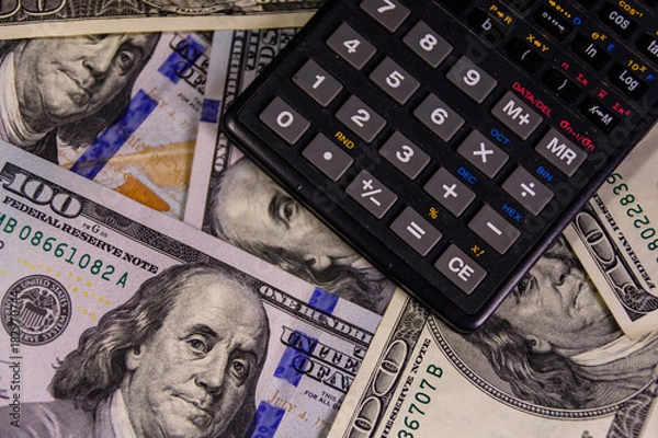 Fototapeta Modern calculator on a one hundred dollar bills