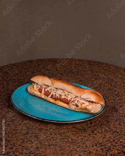 Obraz Hot dog with cheese on a plate
