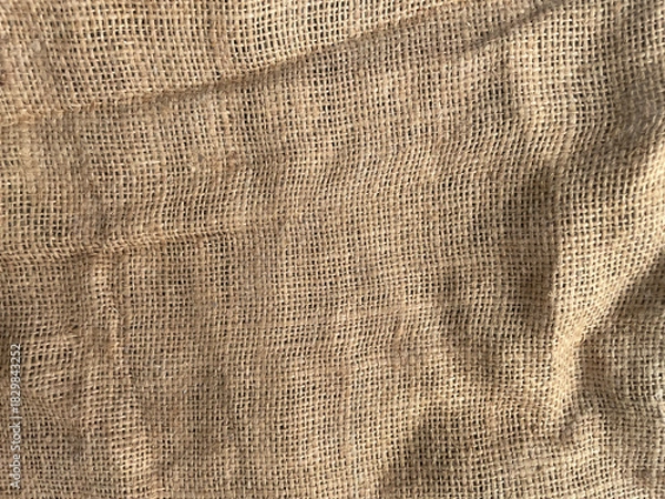 Obraz Natural burlap fabric close-up texture. Beige woven jute material with visible fibers and folds. Rustic background perfect for packaging design, crafts, textiles, eco style, and mockups.