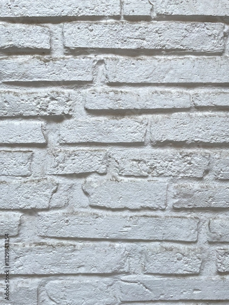 Obraz White brick wall texture with rough, uneven surface and natural imperfections.Bright painted masonry background ideal for design projects,architecture,interiors, patterns,and high-resolution textures