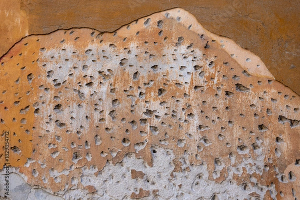 Obraz Detail of a wall with chiseled plaster, showing rough surface prepared for renovation to ensure new plaster adhesion.