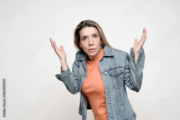 Fototapeta Woman shrugging with hands up expressing confusion reaction