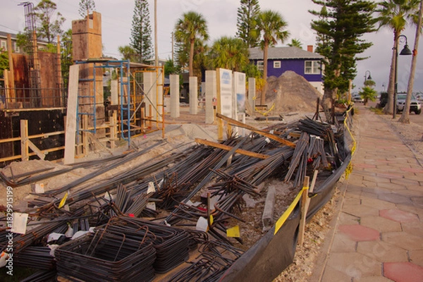 Obraz Active Construction Site With Signage, Rebar, and Wooden Forms in Early Stage Building. In St. Pete Beach, FL. Daylight highlights ongoing development, urban growth, and the sense of industry and prog