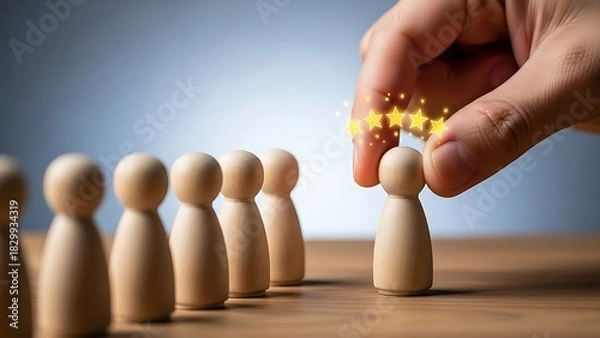 Obraz Hand selecting a wooden figure, awarding it with stars