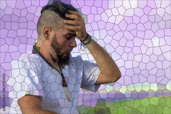 Obraz Young adult male with distressed expression holding forehead in motion-blurred background,