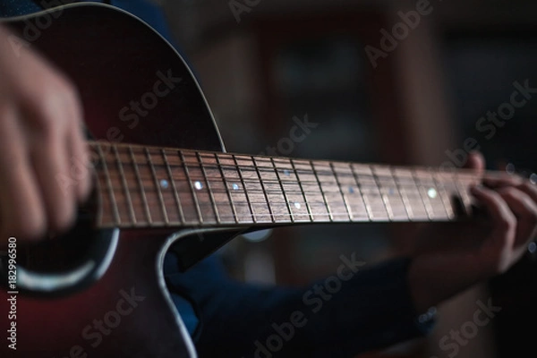 Fototapeta the guy playing the acoustic guitar, closeup, music concept