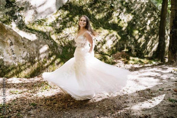 Fototapeta Beautiful stylish bride walking in the forest