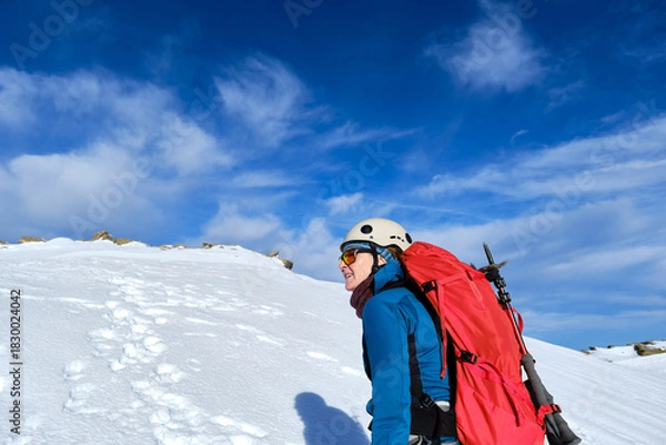 Obraz Solo climber ending the ascent through a snowy mountain couloir