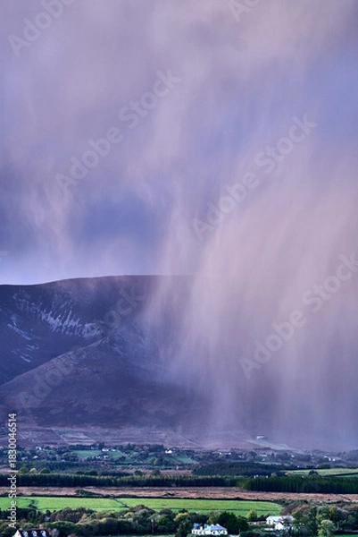 Fototapeta Aerial view of dramatic evening storm clouds at stunning evening in Ireland Co.Mayo, pouring rain beside mountain