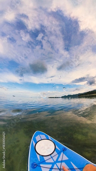 Fototapeta Paddle board on quiet waters on a sunset cloudscape before the storm in Chaweng Beach, Ko Samui