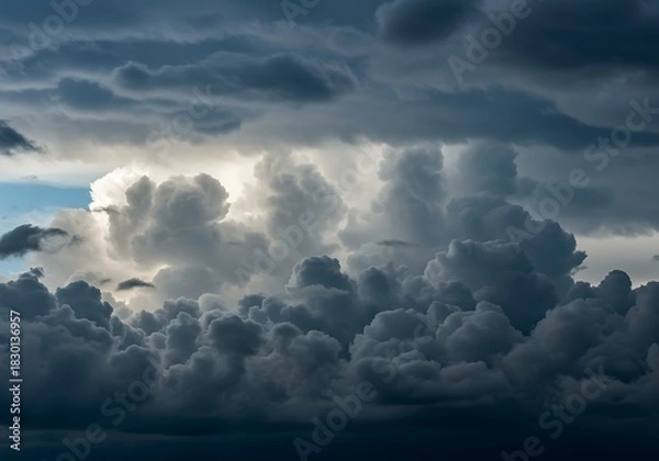 Obraz Dramatic cloudscape with dark gray storm clouds and sunlight peeking through
