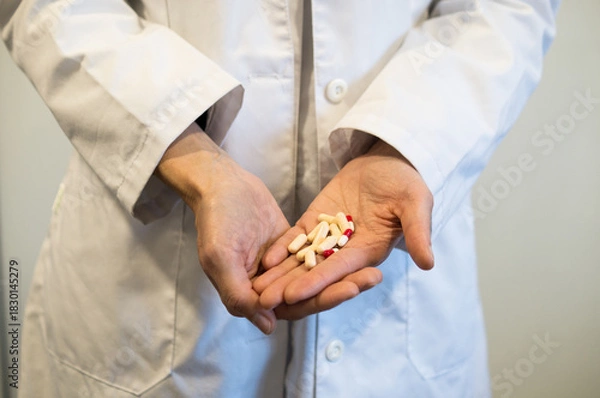 Obraz Doctor's Hands Holding Prescription Pills or Capsules, Medication Management and Treatment