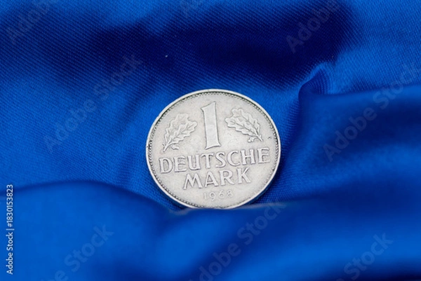 Fototapeta High Quality Macro of a Deutsche Mark Coin on Blue Background to sho Germany in the European Union. High quality photo
