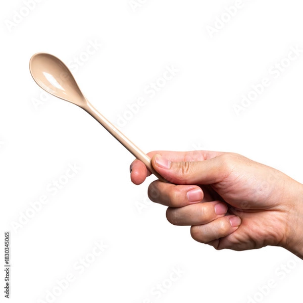 Obraz Male hand holding a brown plastic spoon isolated on white background.