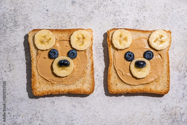 Fototapeta Creative bread slices decorated as cute bear faces with fruit on a light gray countertop