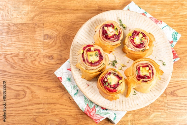 Fototapeta Deliciously baked pastry rolls filled with cherry and cream cheese served on a decorative plate