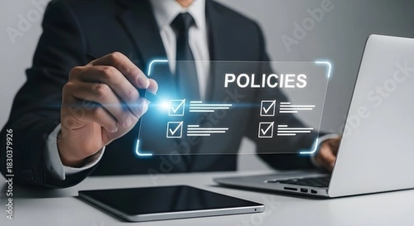 Obraz Businessman reviewing and selecting policies on a digital interface with laptop and tablet