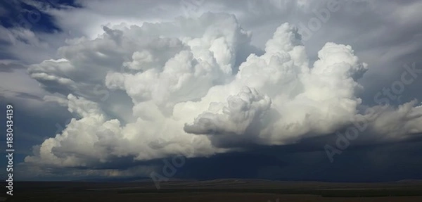 Obraz Dense cumulonimbus clouds building ominously over a dark landscape,  sky,   environment