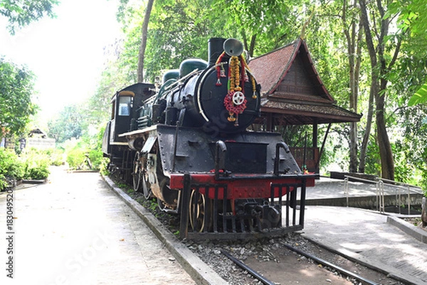 Obraz Old steam locomotive in the countryside. Front view of an antique locomotive that is part of a World War II memorial, when the Japanese army took prisoners of war to build the Death Railway