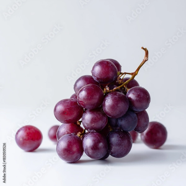 Obraz AI-generated image - A fresh bunch of ripe, red grapes with several loose berries, isolated on a clean white background.