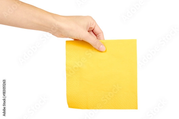 Fototapeta Yellow paper napkin for food in hand isolated on white background. Kitchen serving object.
