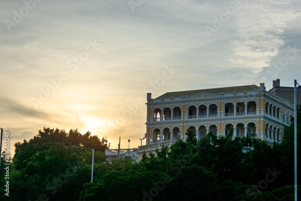Obraz Sunset and an old building at dusk