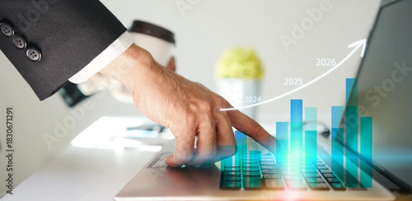 Fototapeta Businessman using laptop to analyze performance with business analytics dashboard. strategy planning and growth opportunities, calculating company investment