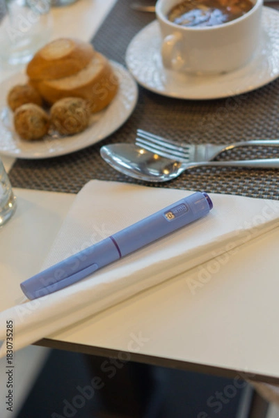 Fototapeta diabetes medication injection pen Ozempic soup meal restaurant table setting blue device white napkin fork close up gray placemat concept of healthcare nutrition and diet