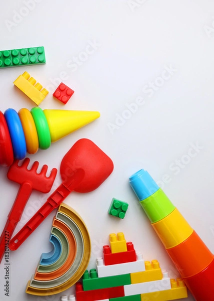 Obraz A vibrant display of childrens toys on a bright yellow backdrop, perfect for playful themes and joyful imagination. Vertical photo format