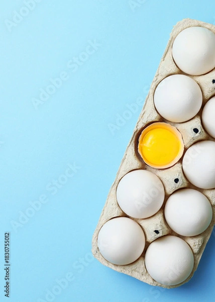 Fototapeta fresh farm chicken eggs on a colored background. Vertical photo format
