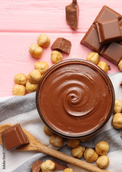 Obraz chocolate paste with a bowl on a table.  Vertical photo format