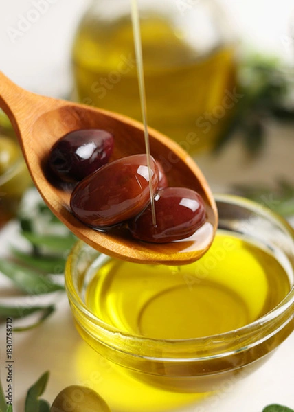 Fototapeta Vertical photo format. A premium olive oil with olives and fresh leaves, top view 