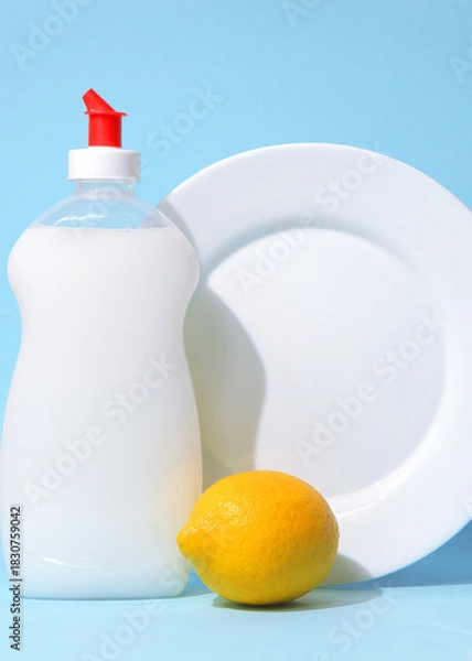Fototapeta Vertical photo format.Dishwashing detergent and lemons on a light background