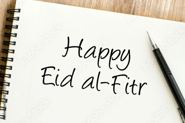 Obraz Warm wishes for Eid al Fitr, a festive occasion marking the end of Ramadan, written elegantly on a desk notepad