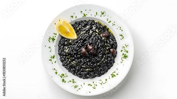 Fototapeta Black risotto with olives and lemon slice on white plate with parsley garnish squid ink risotto