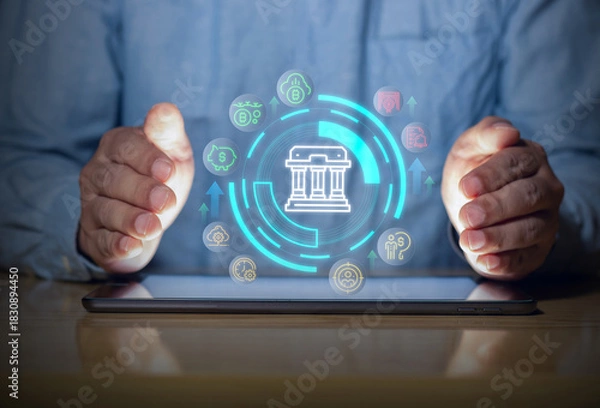 Fototapeta Digital banking protection with secure financial interface on tablet, showing money, savings and fintech icons with hands guarding the system.