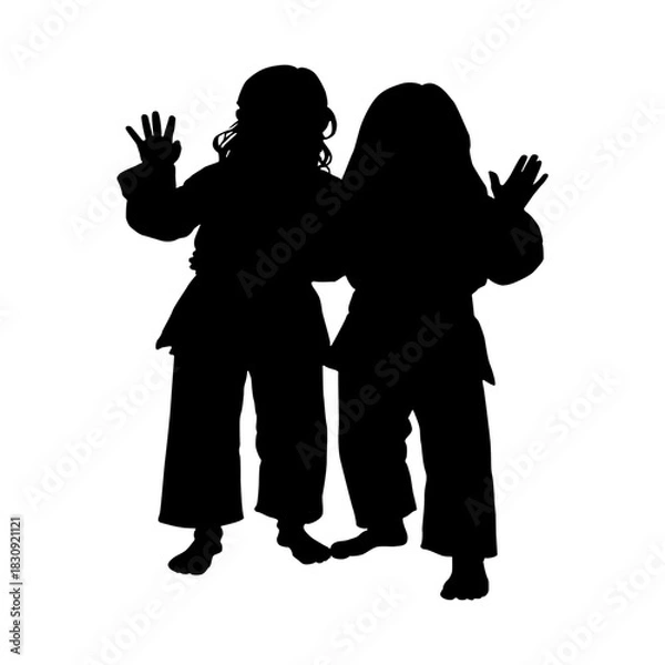 Obraz Silhouette of two young girls practicing martial arts together in uniforms