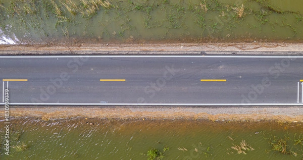 Fototapeta road with water on both sides