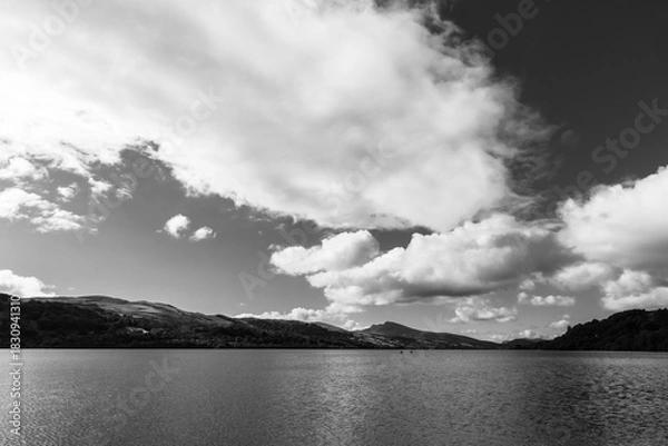 Fototapeta Bala lake with high altitude white fluffy clouds in black and white