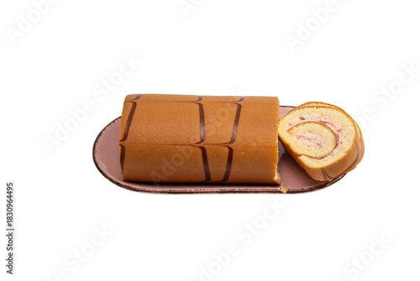 Obraz Swiss roll cake on a rectangular plate with one slice served beside, isolated on white. Strawberry cream sponge roll with chocolate stripe decoration.