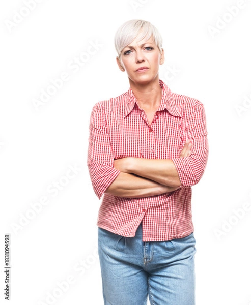 Obraz Portrait of serious adult woman, strict middle aged woman with hands on waist looking to camera, isolated on white background.
