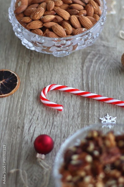 Fototapeta Various Christmas decorations, cookies, chocolate and nuts on wooden background. Selective focus.