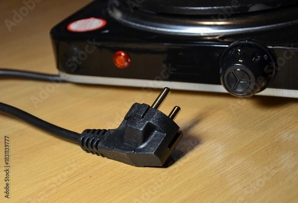 Fototapeta electric plug of an electric stove close-up. concept of using household electrical appliances