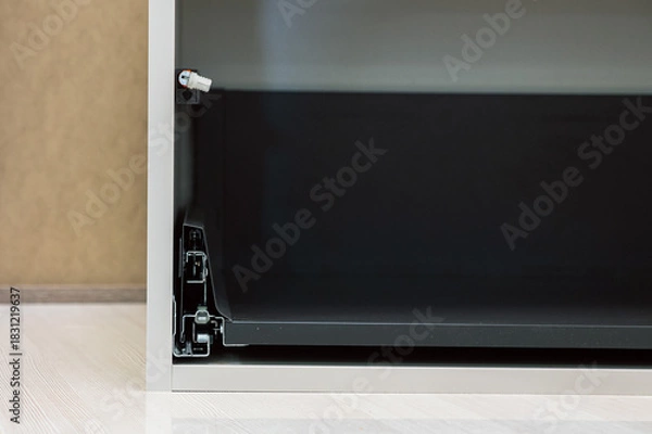 Fototapeta close-up of a drawer slide mechanism. Concept of smooth operation, engineering, and functional design is conveyed.