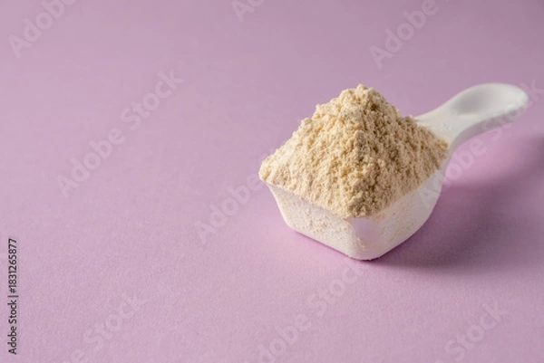Obraz Spoon with protein on colored background.