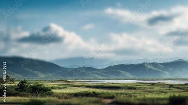Fototapeta Tranquil mountainous landscape featuring a marshy meadow and cloudy skies