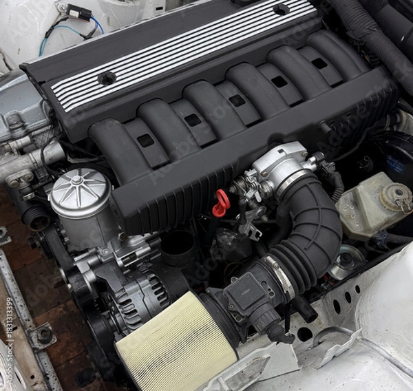 Obraz Close view of an engine compartment with a modern motor, showcasing performance parts and design