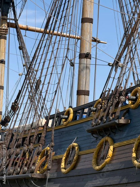 Obraz Close-up of a historic ship’s rigging and hull with bright sky in background